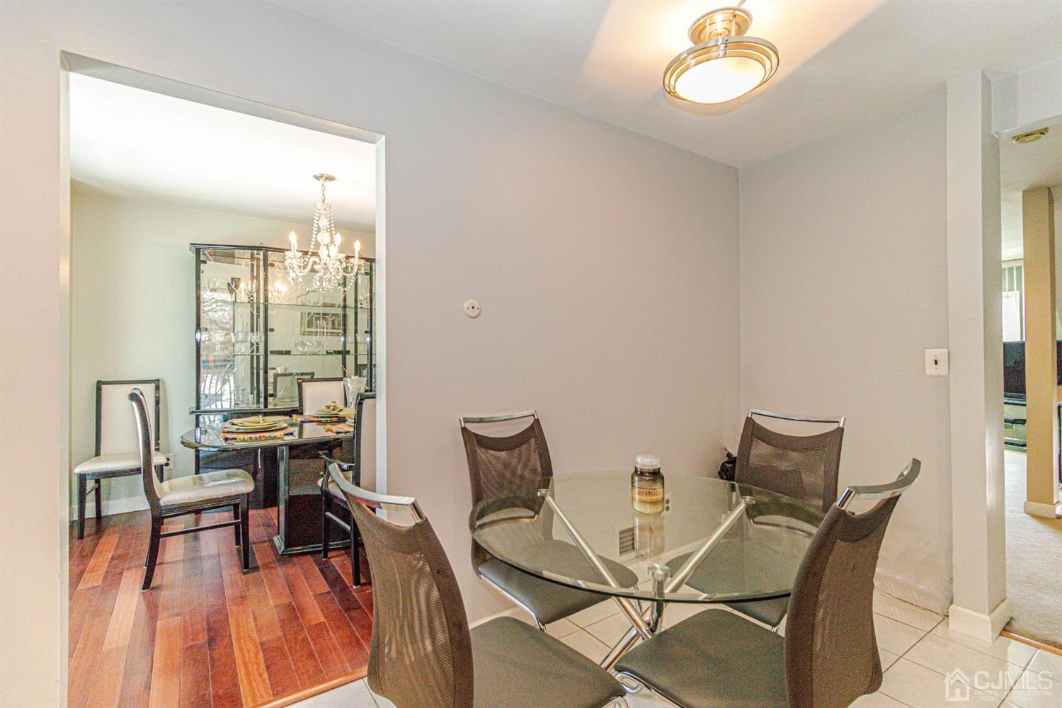 6803 Hana Road Edison, NJ 08817 - Photo 6 of 25 a dining room with furniture and wooden floor
