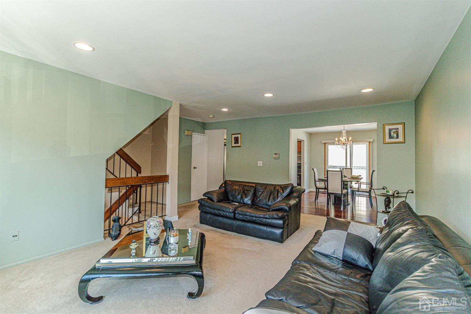 6803 Hana Road Edison, NJ 08817 - Photo 10 of 25 a living room with furniture gym equipment and a view of kitchen