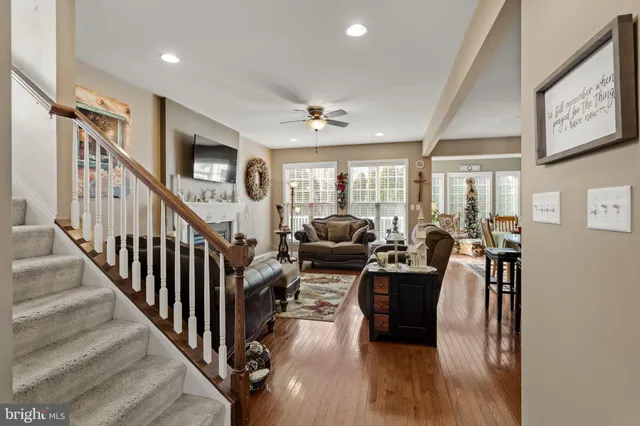 a living room with furniture or wooden floor and a chandelier