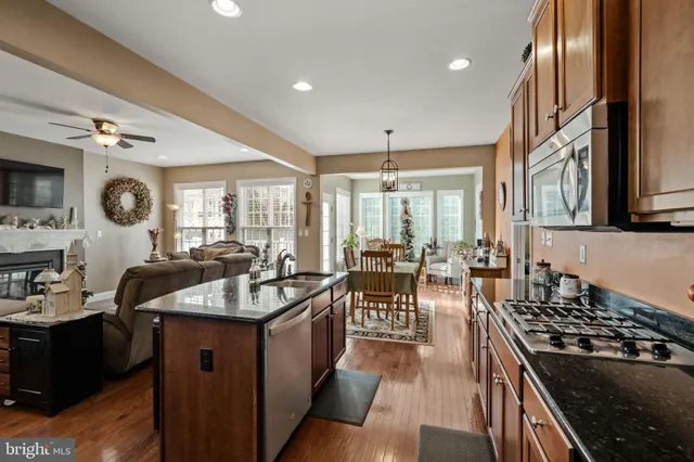 a kitchen with sink stove and cabinets