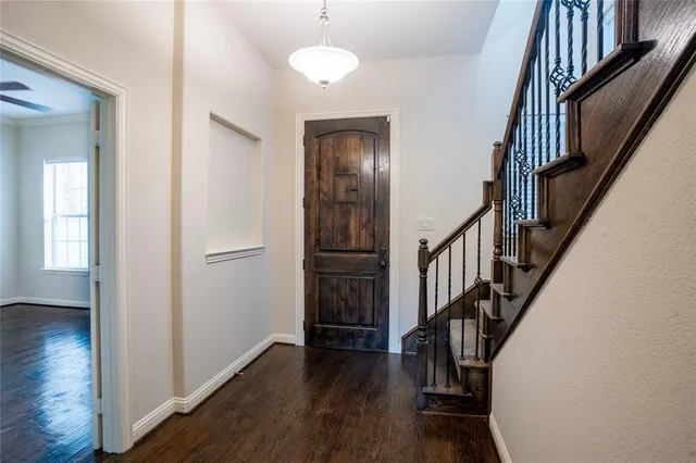a view of front door with wooden floor and stairs