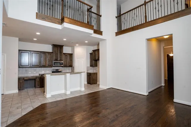 a kitchen with stainless steel appliances kitchen island granite countertop a refrigerator and a stove top oven
