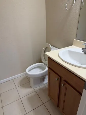 a view of an empty room with wooden floor and a chandelier