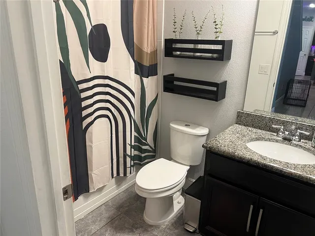 a bathroom with a toilet a sink and a mirror