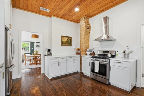 a kitchen with stainless steel appliances a stove top oven and sink