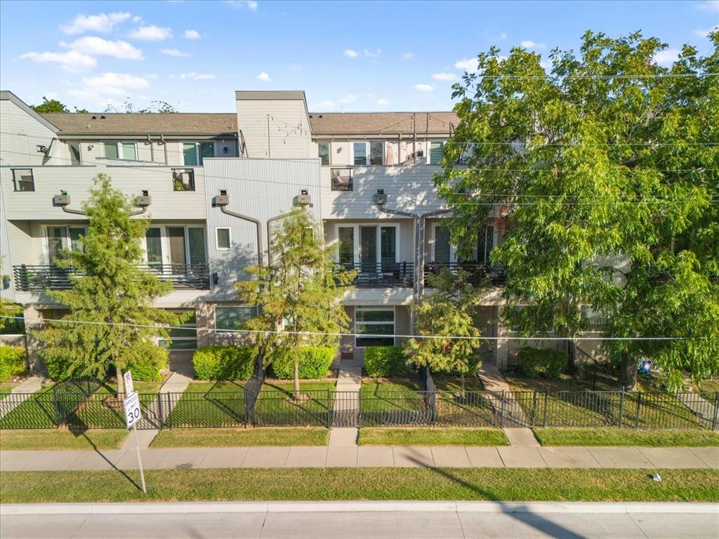 a front view of residential houses with yard