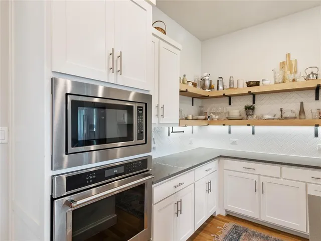 a kitchen with stainless steel appliances granite countertop a sink and cabinets