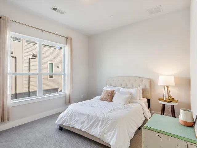 a bedroom with a large bed and a window