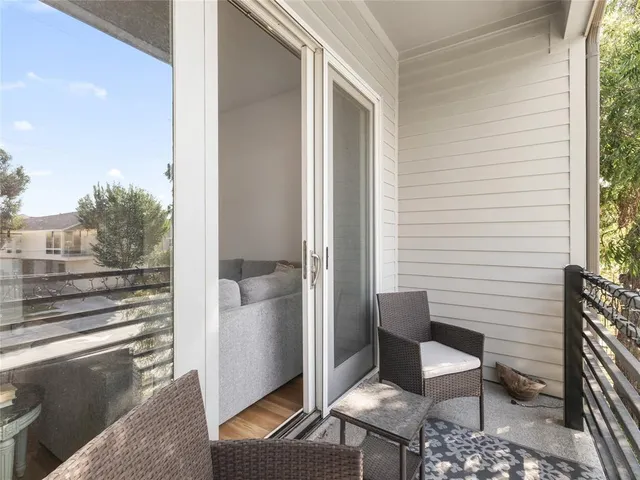 a porch with a bench and chair
