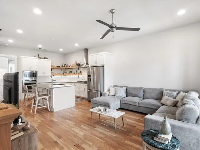 a living room with furniture and kitchen view