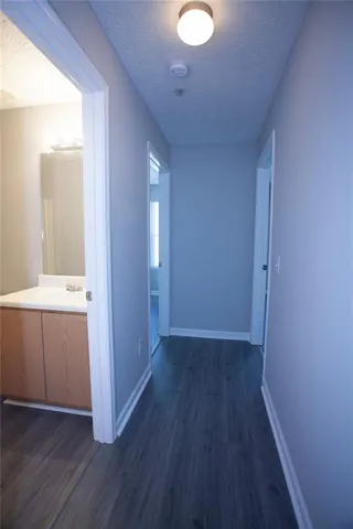 an empty room with wooden floor and cabinet