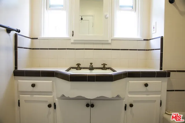 a bathroom with a sink and a window