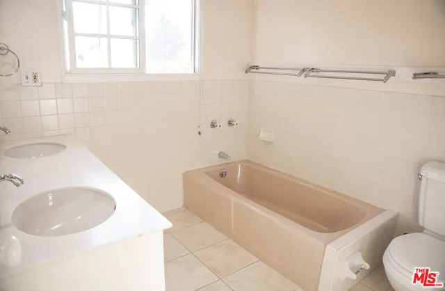 a bathroom with a sink a toilet and bathtub