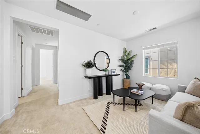 a bedroom with a bed a couch and a window