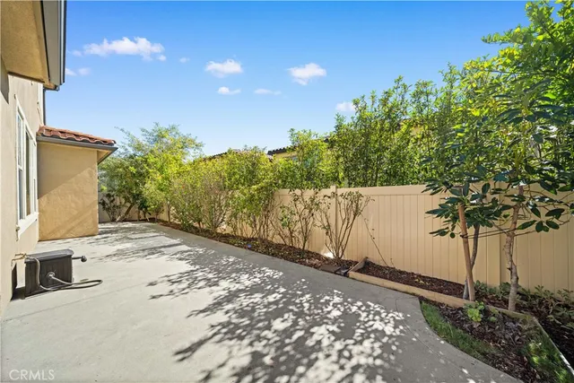 a view of a white house with many windows next to a road