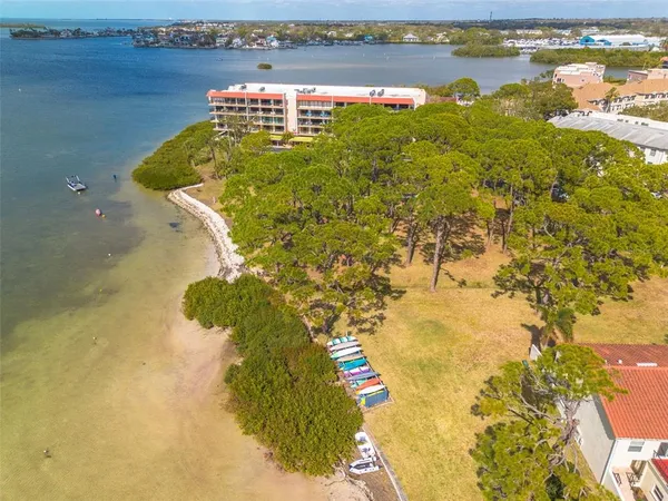 a dining hall with stainless steel appliances granite countertop a barbecue grill and couches with wooden floor
