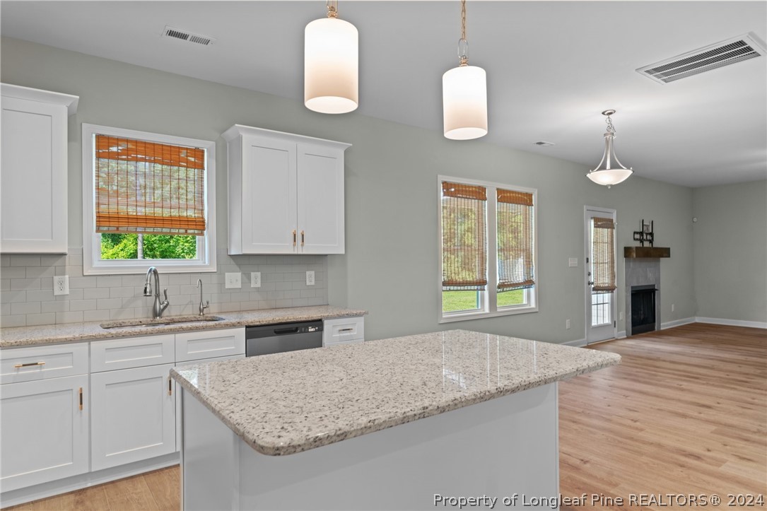 2632 Riddle Farm Road Fayetteville, NC 28306 - Photo 16 of 45 a kitchen with granite countertop a sink a window stainless steel appliances and cabinets