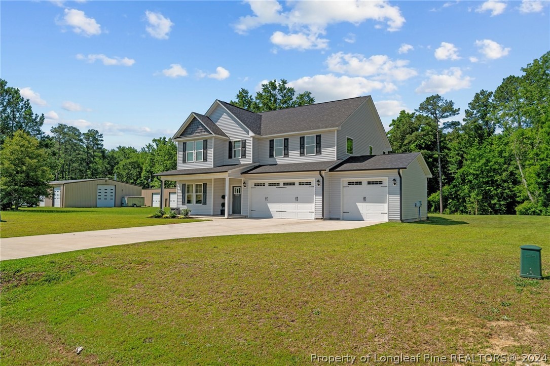 2632 Riddle Farm Road Fayetteville, NC 28306 - Photo 3 of 45 a front view of a house with a garden and deck
