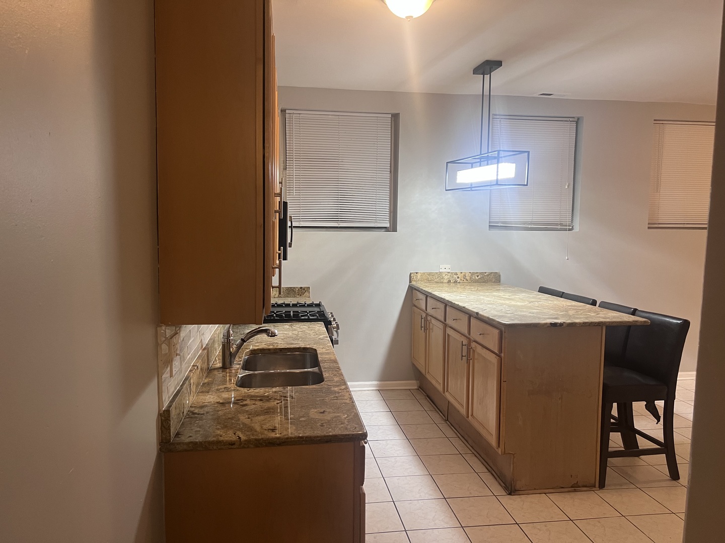 1430 East 69th Street, Unit 1S Chicago, IL 60637 - Photo 7 of 16 a utility room with granite countertop a sink and a stove