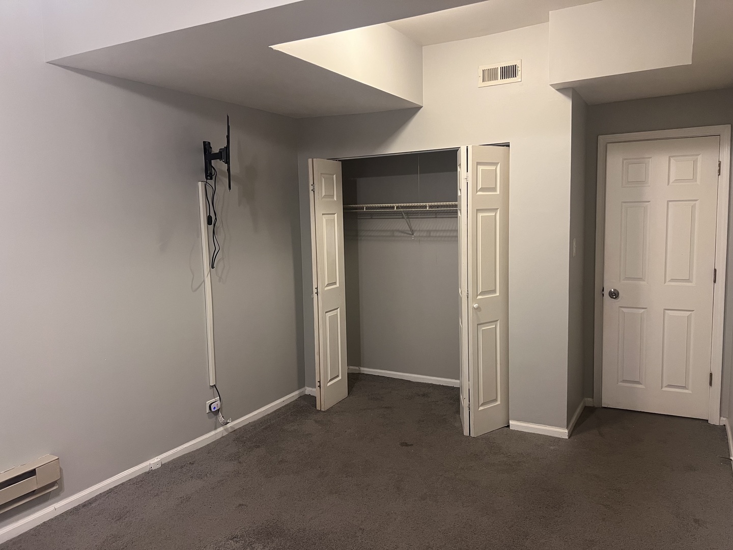 1430 East 69th Street, Unit 1S Chicago, IL 60637 - Photo 10 of 16 an empty room with closet and wooden floor