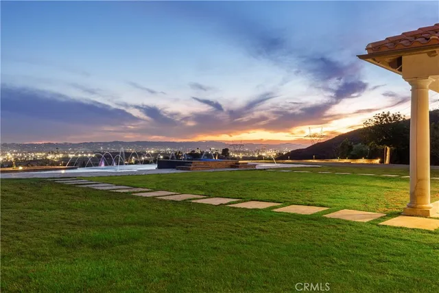 a view of swimming pool with outdoor seating and yard in back