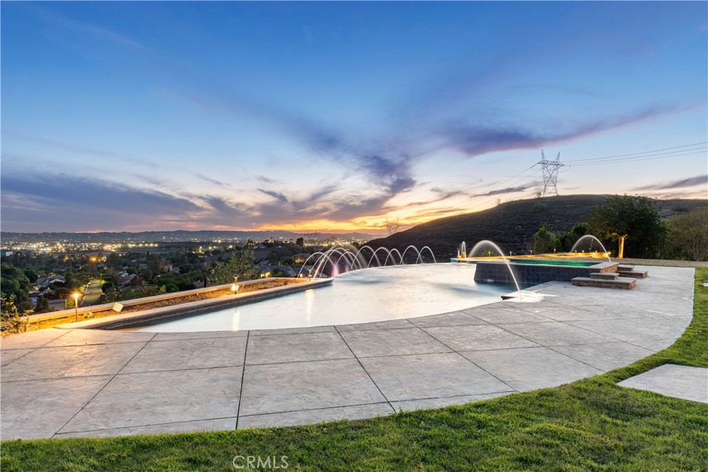 10727 West Stallion Ranch Road Shadow Hills, CA 91040 - Photo 12 of 39 a view of swimming pool with outdoor seating and yard in back