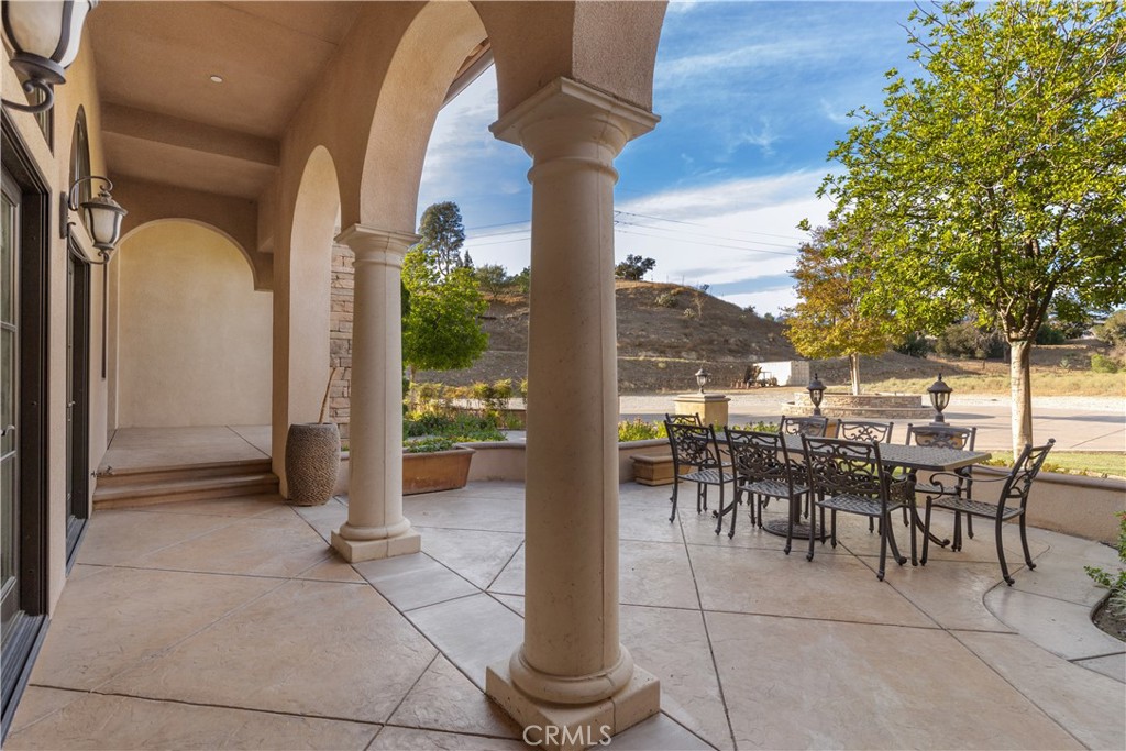 10727 West Stallion Ranch Road Shadow Hills, CA 91040 - Photo 14 of 39 a view of a patio with dining table and chairs