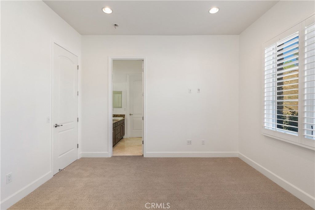 10727 West Stallion Ranch Road Shadow Hills, CA 91040 - Photo 27 of 39 an empty room with windows