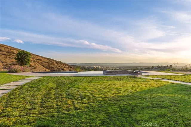 a view of swimming pool with outdoor seating and yard in the back