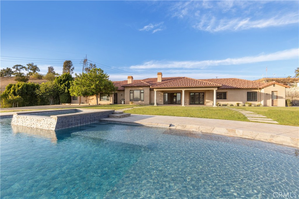 10727 West Stallion Ranch Road Shadow Hills, CA 91040 - Photo 33 of 39 a view of swimming pool with outdoor seating and yard in the back