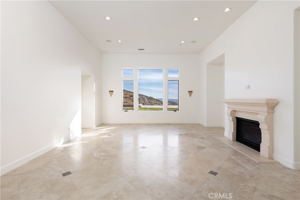 10727 West Stallion Ranch Road Shadow Hills, CA 91040 - Photo 4 of 39 a view of an empty room with a fireplace