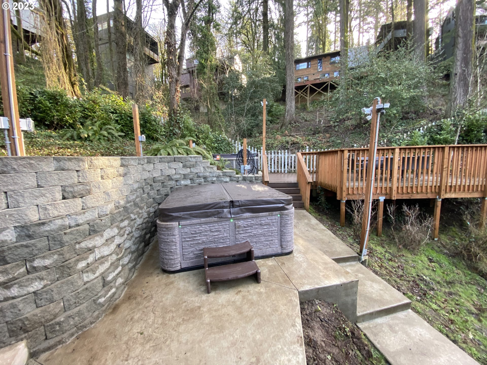 4224 Southwest Melville Avenue Portland, OR 97239 - Photo 11 of 48 a view of a wooden deck with chairs and a fire pit