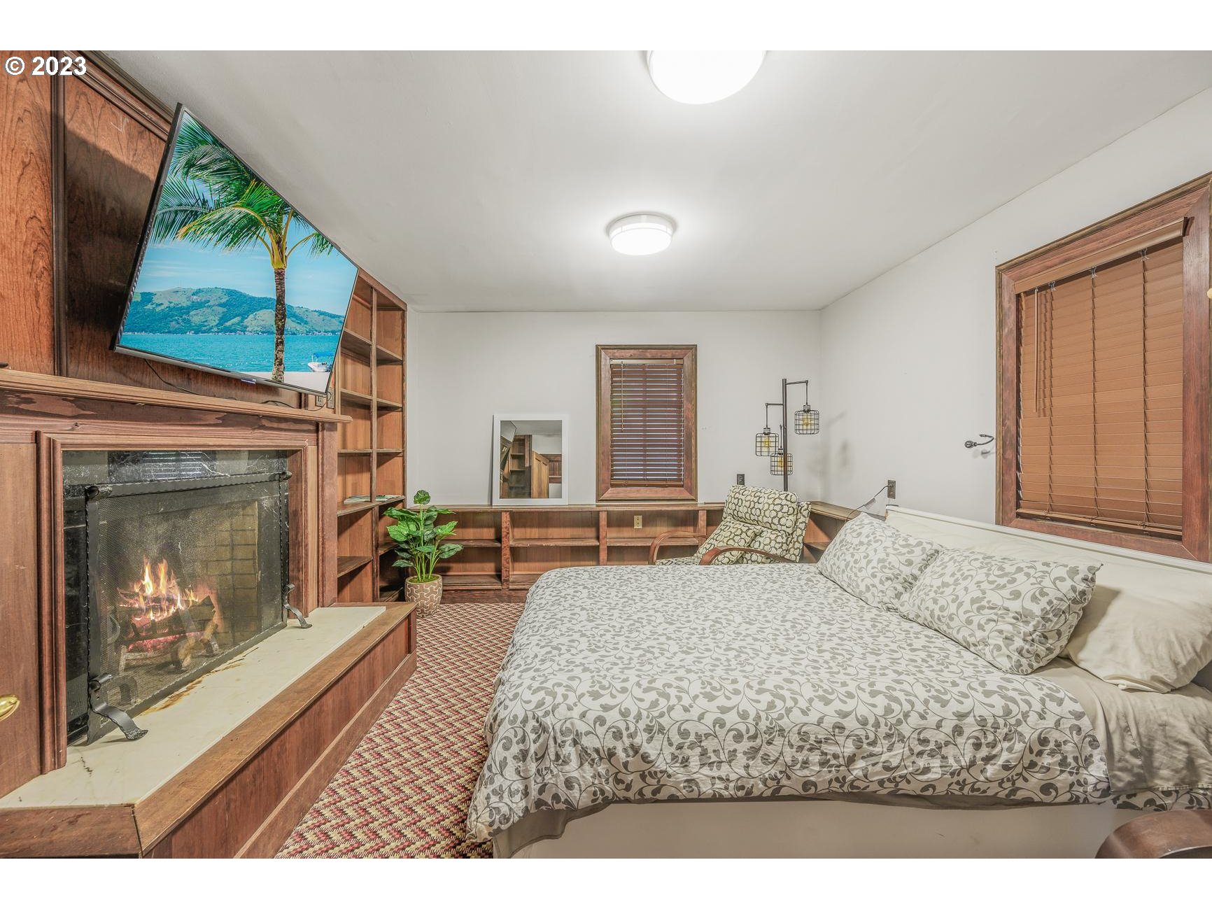 4224 Southwest Melville Avenue Portland, OR 97239 - Photo 19 of 48 a living room with a bed furniture and a fireplace