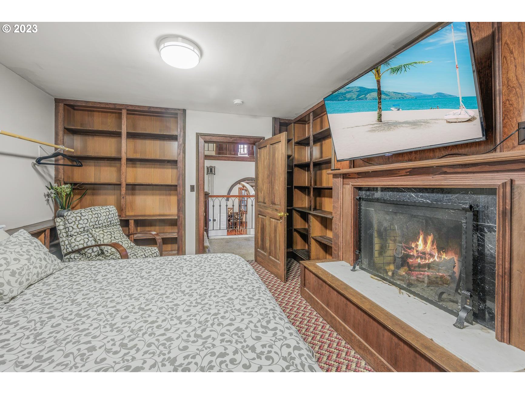 4224 Southwest Melville Avenue Portland, OR 97239 - Photo 20 of 48 a bedroom with a bed and a fireplace