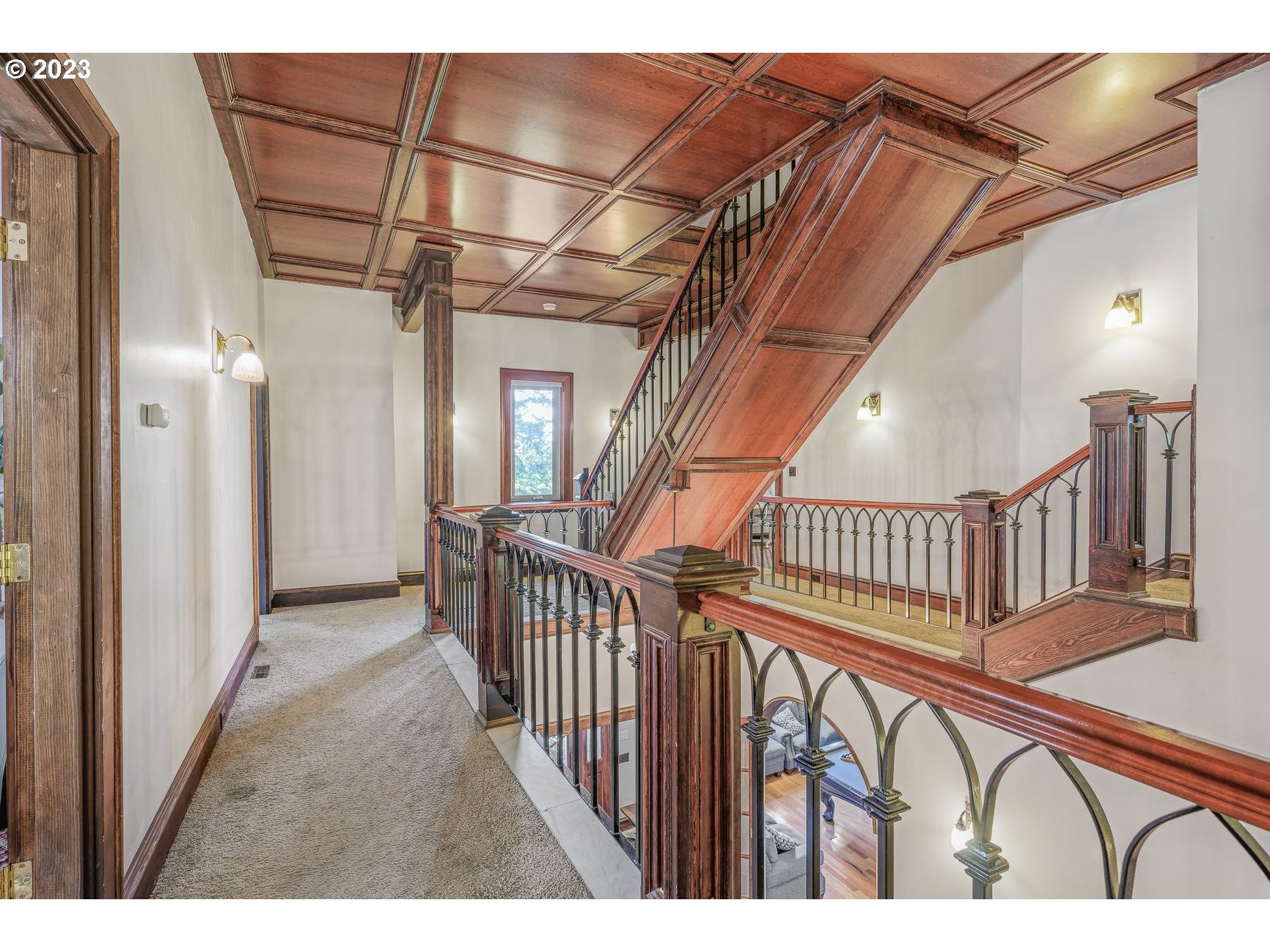 4224 Southwest Melville Avenue Portland, OR 97239 - Photo 22 of 48 a view of staircase with railing and a chandelier