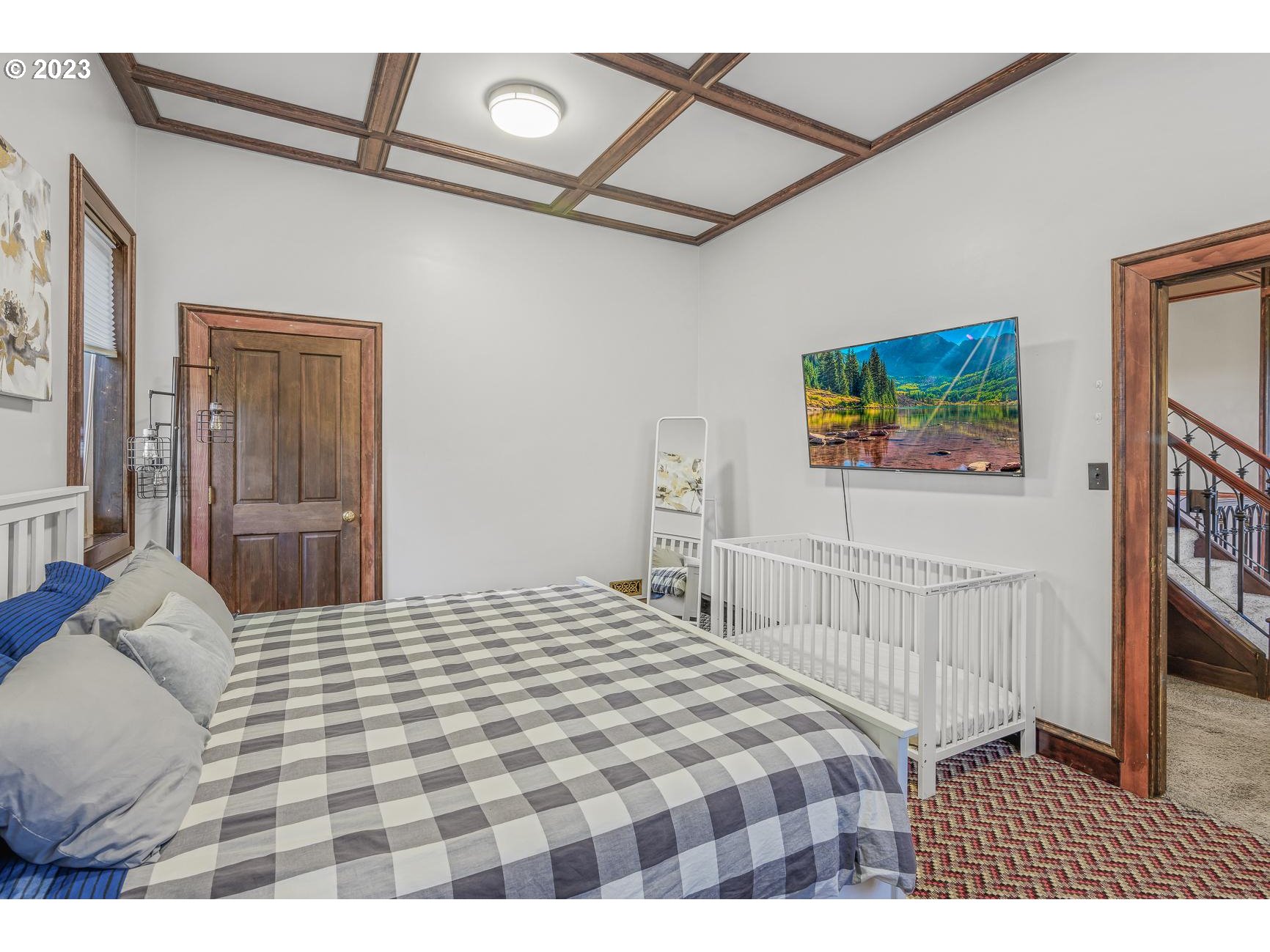 4224 Southwest Melville Avenue Portland, OR 97239 - Photo 29 of 48 a bedroom with a bed and a painting on the wall