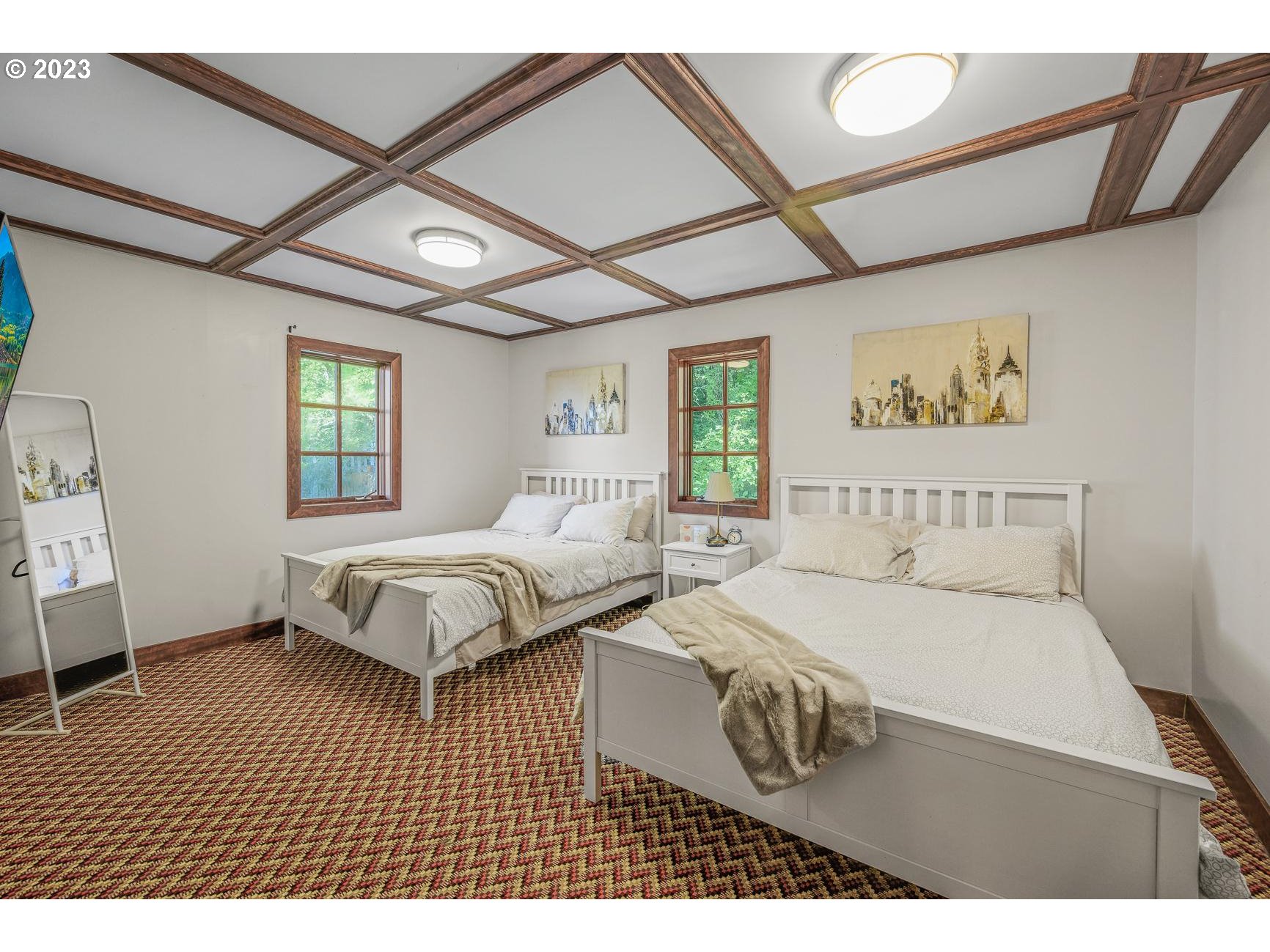 4224 Southwest Melville Avenue Portland, OR 97239 - Photo 30 of 48 a bedroom with a large bed and a window