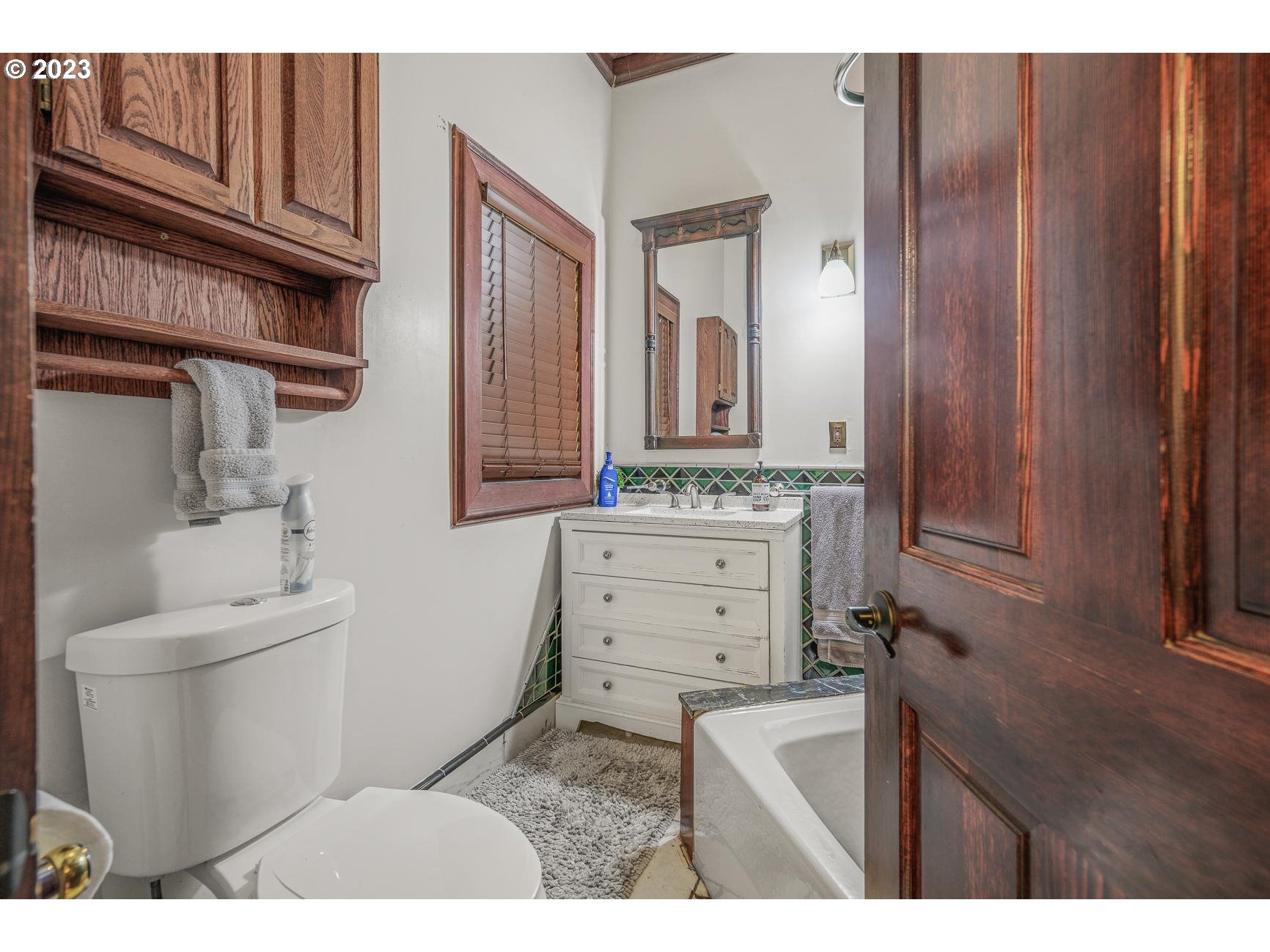 4224 Southwest Melville Avenue Portland, OR 97239 - Photo 36 of 48 a bathroom with a sink a toilet and mirror