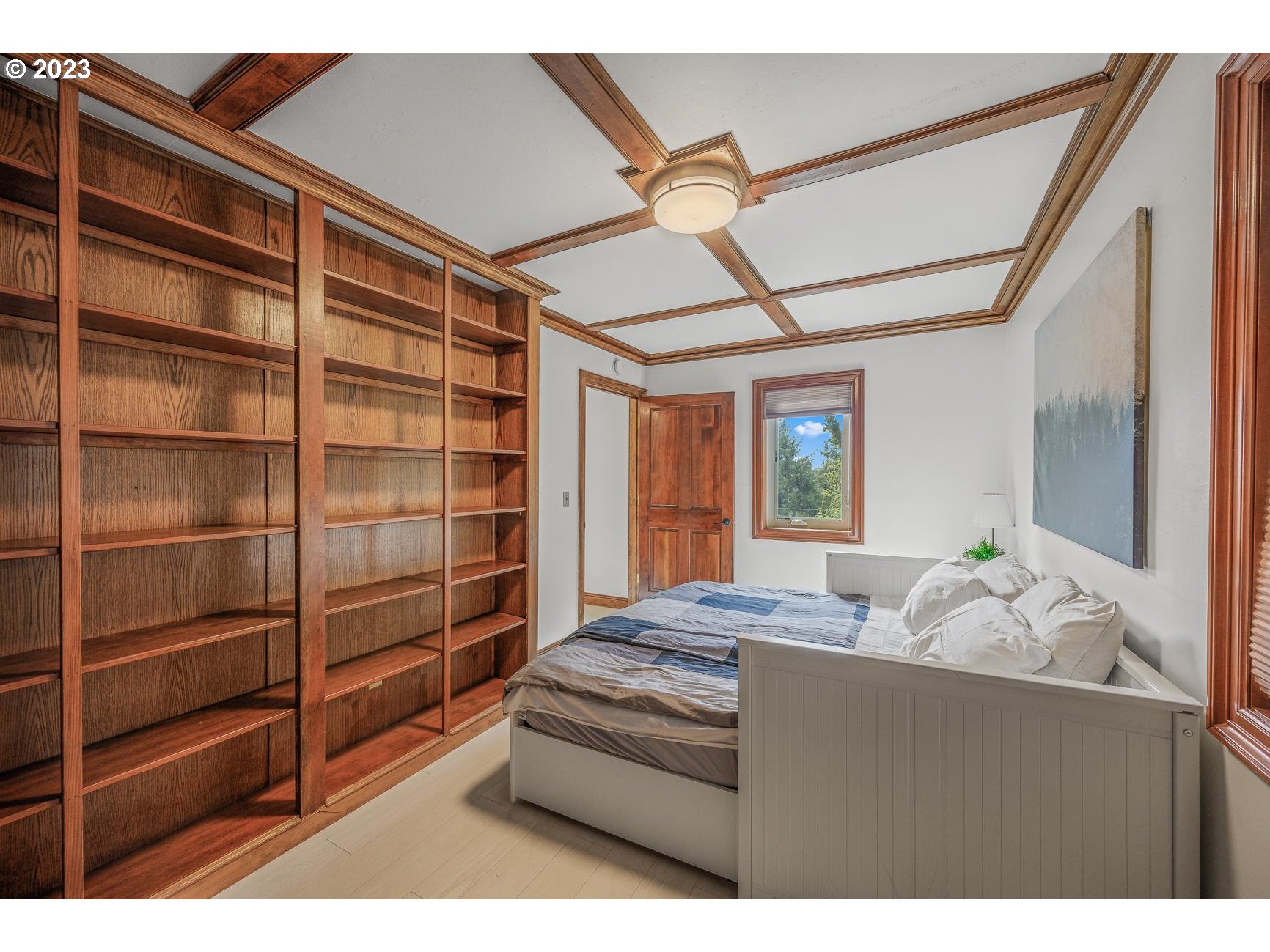 4224 Southwest Melville Avenue Portland, OR 97239 - Photo 42 of 48 a bedroom with a bed and a window