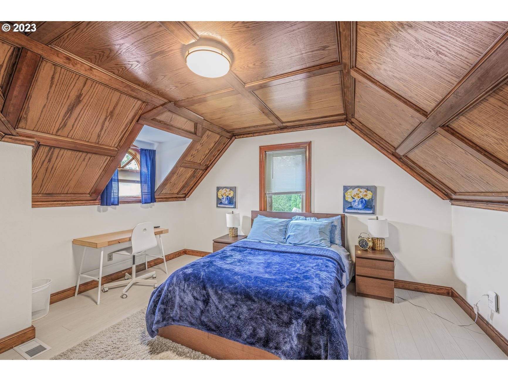 4224 Southwest Melville Avenue Portland, OR 97239 - Photo 43 of 48 a bedroom with a bed window and flowerpot