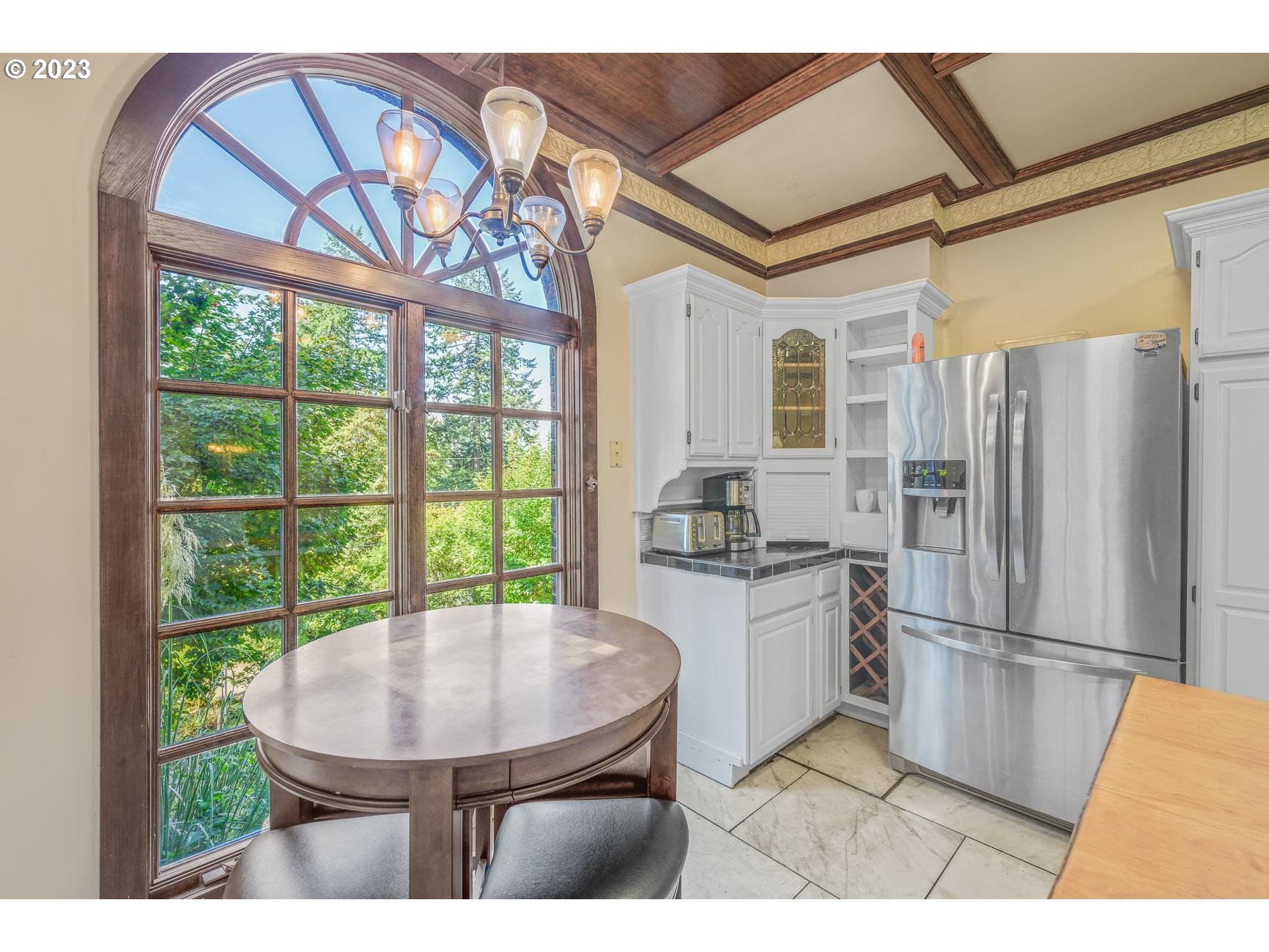 4224 Southwest Melville Avenue Portland, OR 97239 - Photo 48 of 48 a kitchen with a table chairs refrigerator and a sink