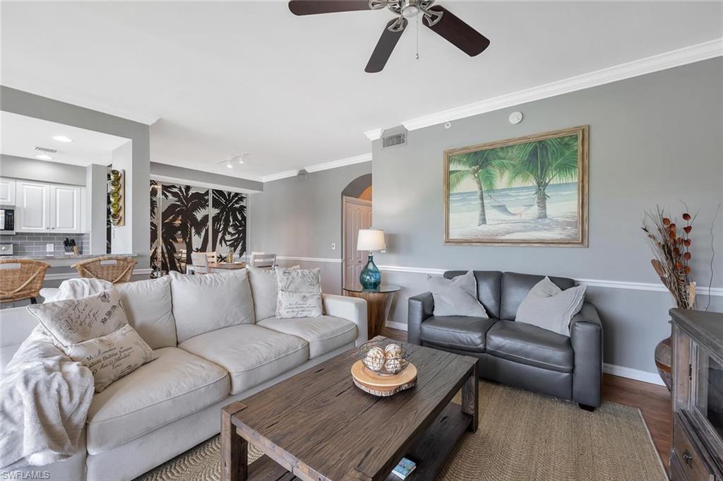 8600 Cedar Hammock Circle, Unit 1313 Naples, FL 34112 - Photo 12 of 48 a living room with furniture and a wooden floor