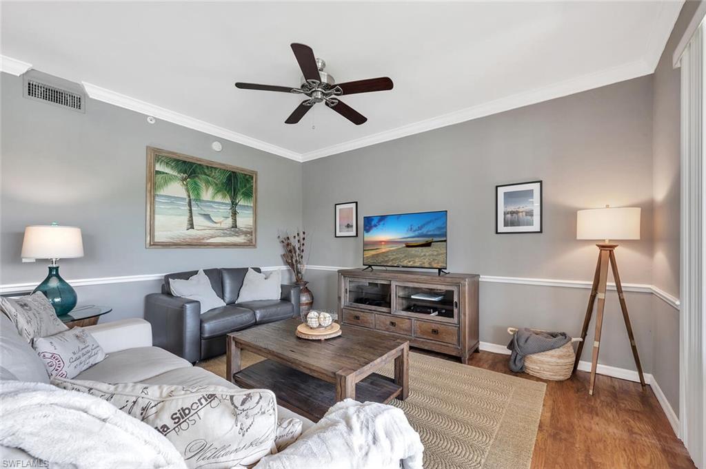 8600 Cedar Hammock Circle, Unit 1313 Naples, FL 34112 - Photo 13 of 48 a living room with furniture and a flat screen tv