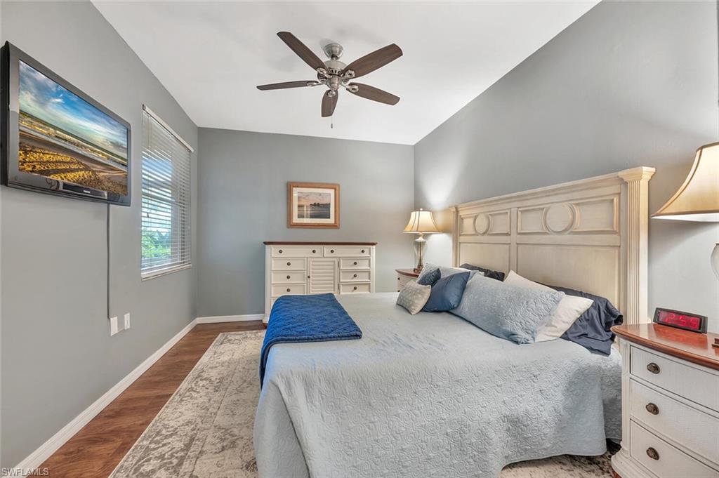 8600 Cedar Hammock Circle, Unit 1313 Naples, FL 34112 - Photo 17 of 48 a bedroom with a large bed and a chandelier