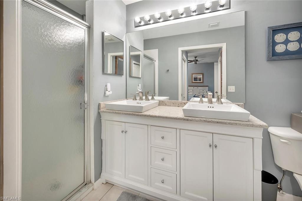 8600 Cedar Hammock Circle, Unit 1313 Naples, FL 34112 - Photo 19 of 48 a bathroom with a sink vanity and mirror