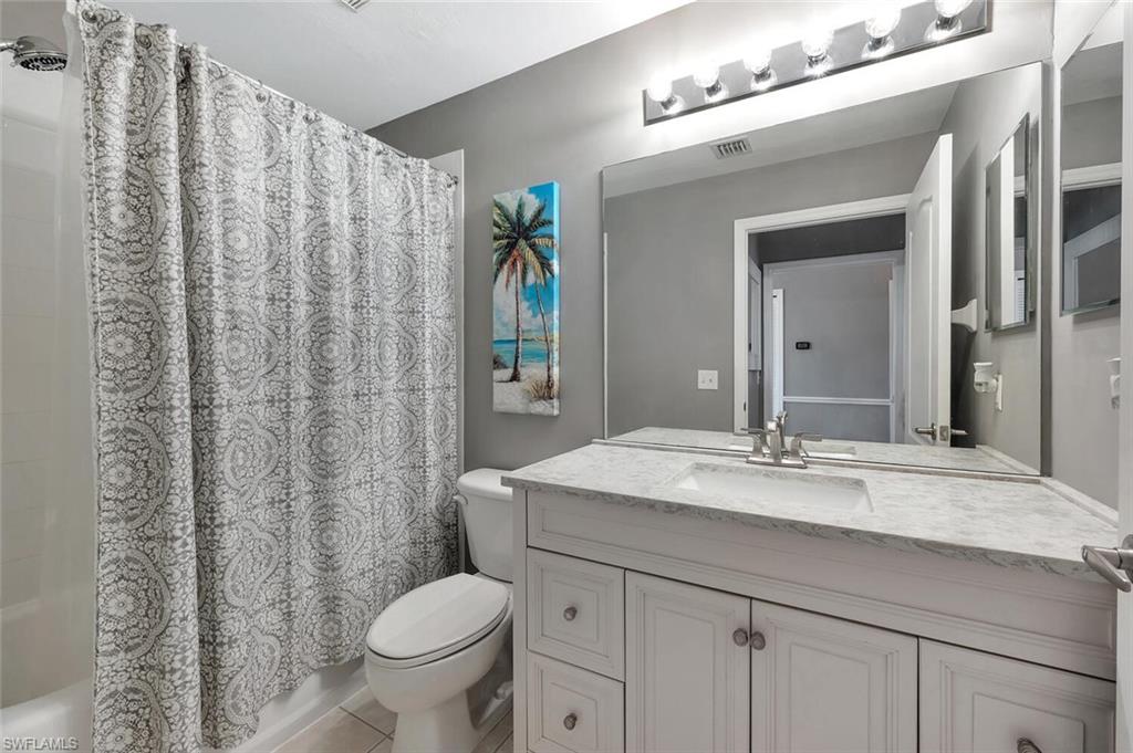 8600 Cedar Hammock Circle, Unit 1313 Naples, FL 34112 - Photo 21 of 48 a bathroom with a granite countertop sink toilet and a mirror