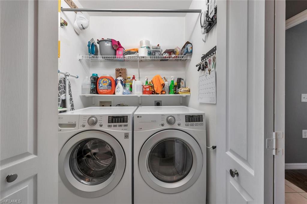 8600 Cedar Hammock Circle, Unit 1313 Naples, FL 34112 - Photo 22 of 48 a utility room with dryer and washer