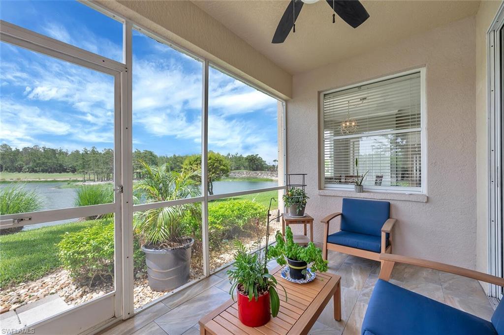 8600 Cedar Hammock Circle, Unit 1313 Naples, FL 34112 - Photo 23 of 48 a living room with a floor to ceiling window and wooden floor