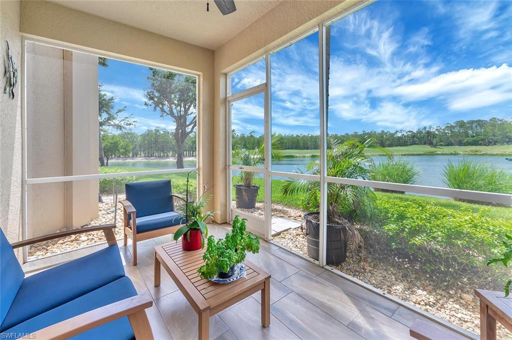 8600 Cedar Hammock Circle, Unit 1313 Naples, FL 34112 - Photo 24 of 48 a porch with a bench next to a yard