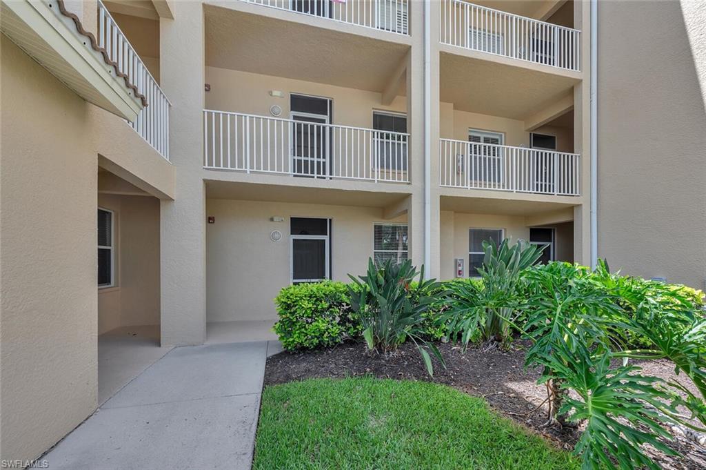 8600 Cedar Hammock Circle, Unit 1313 Naples, FL 34112 - Photo 25 of 48 front view of a house with a yard